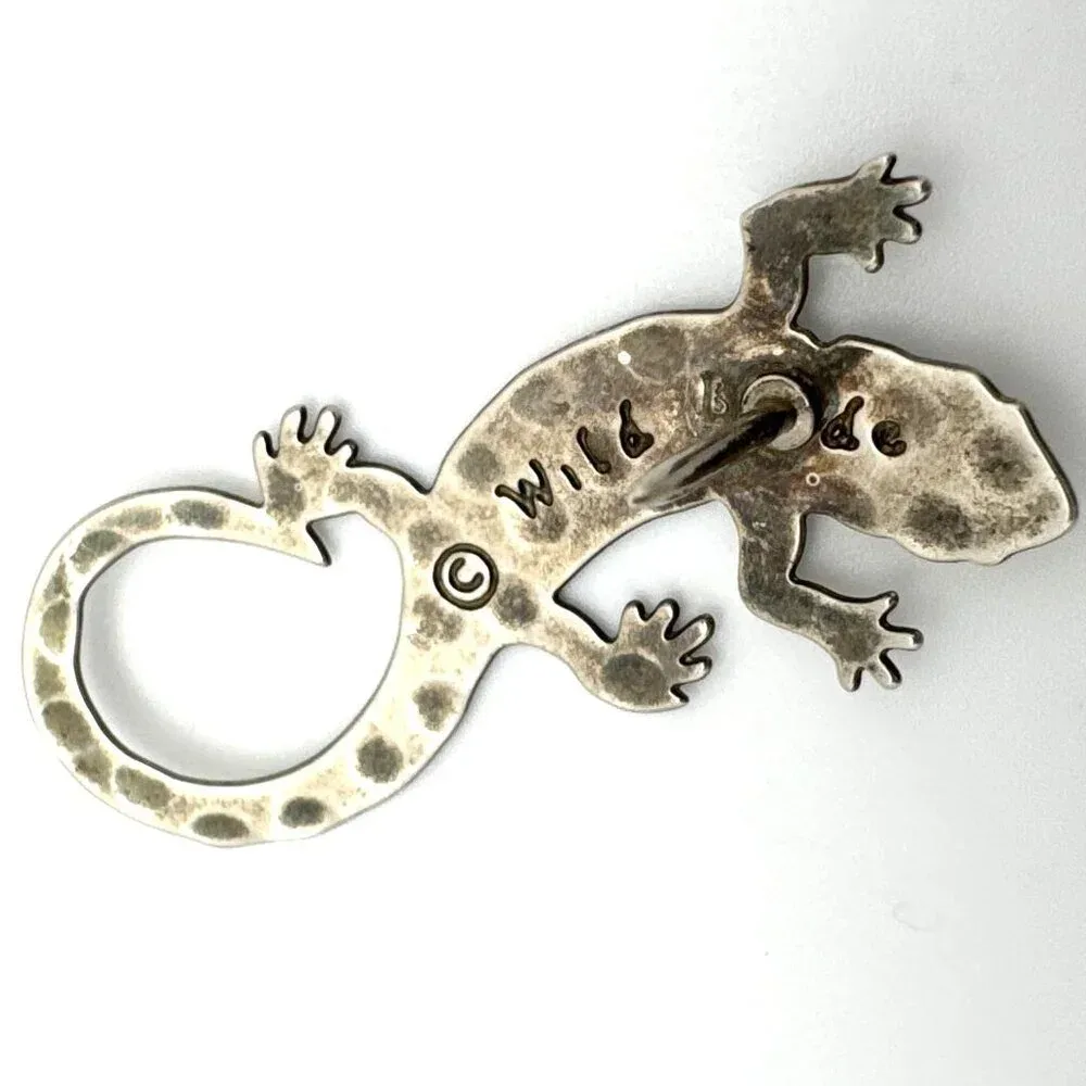 Brass tarnish visible through rhodium plating Brass tarnish visible through rhodium plating